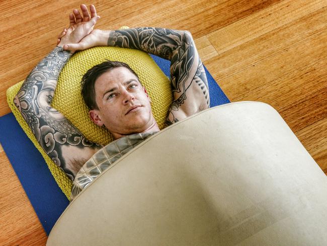 Nick Hall sweats it out in his infra-red sauna at his home. Picture: Colleen Petch