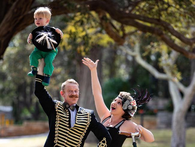 Portraits of entertainers "Bees Wax and Bottle Caps" who will be performing at this months Screen on the Green in Hornsby at the showing of "The Greatest Showman". Pictured in Hornsby Park on 6th September 2018 are George Le Couteur (riding bike) and his partner Lil Tulloch and their sone Harpo Le Couture (18 months) from Woy Woy. (AAP Image / Julian Andrews).