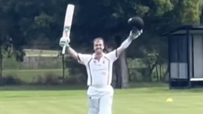 Tom Morris raises his bat after reaching 200.