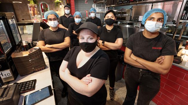 MELBOURNE, AUSTRALIA - NewsWire Photos MARCH 17, 2022:  Staff at Burgertory in Box Hill having to wear masks while customers do not.Three of VictoriaÃs key business lobby groups are calling for the stateÃs hospitality and retail workers to be unmasked. Under current restrictions, hundreds of thousands of workers must wear masks, while customers are not required to do so.Picture: NCA NewsWire / David Geraghty.