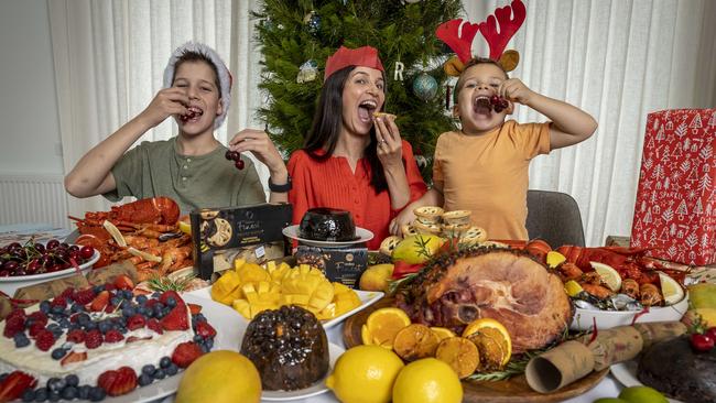 Rosie Waters and her sons Harvey, 11, and Hugo, 6, tuck into Australians’ favourite foods for Christmas lunch. Picture: Jake Nowakowski