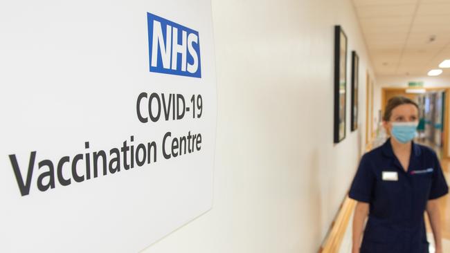 A nurse passes a sign indicating a COVID-19 Vaccination Centre at the Royal Free Hospital in London. Picture: Dominic Lipinski/AFP