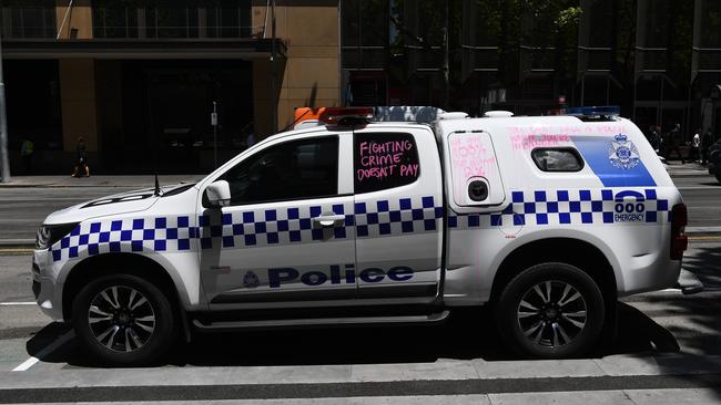 Victoria Police car with slogans written in chalk based paint. Picture: AAP