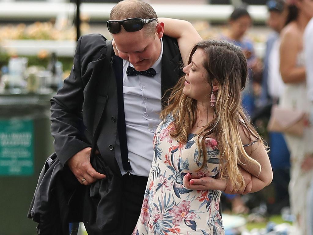 MELBOURNE, AUSTRALIA - NOVEMBER 06: A racegoer loses her shoe in the mud as they make their way home following Melbourne Cup Day at Flemington Racecourse on November 6, 2018 in Melbourne, Australia. (Photo by Scott Barbour/Getty Images)