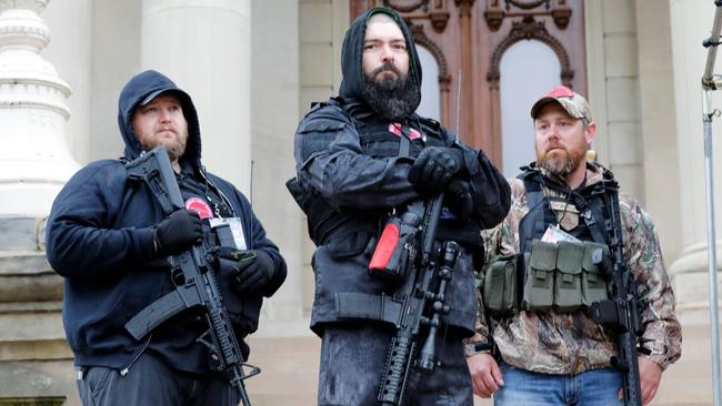 Armed protesters provide security as demonstrators take part in an American Patriot Rally on the steps of the Michigan State Capitol in Lansing. Picture: AFP