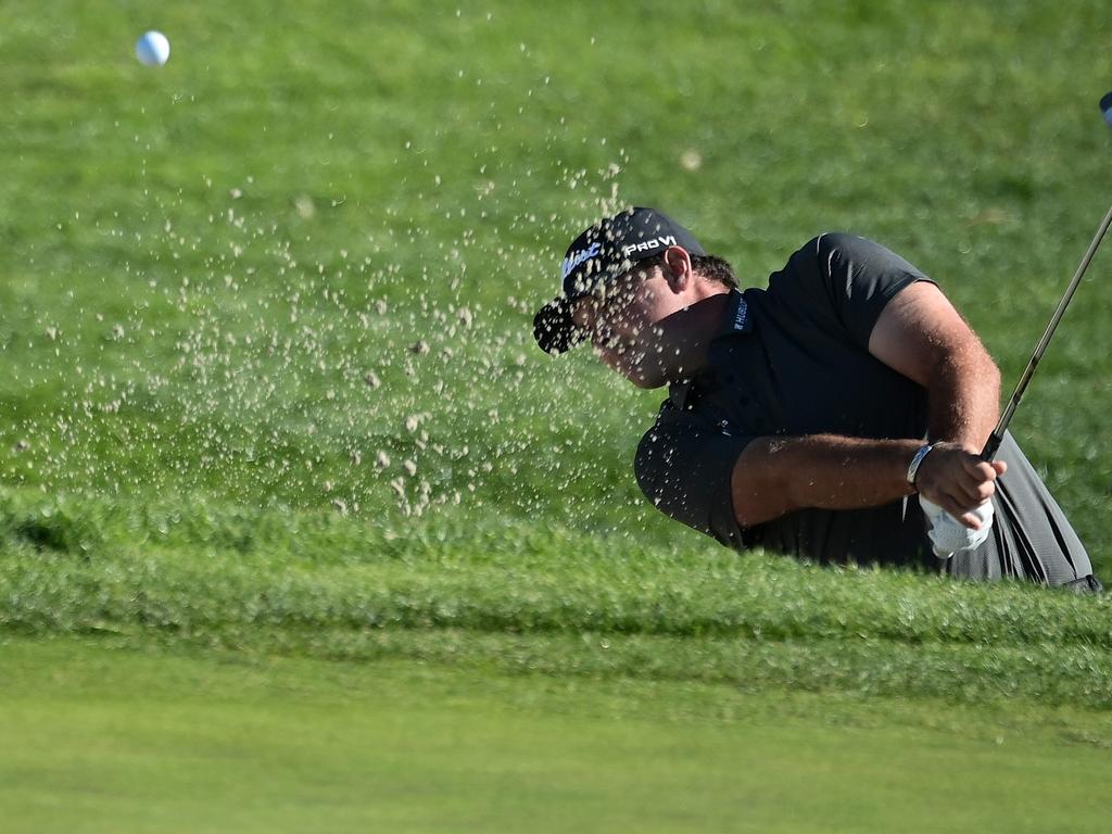 Patrick Reed hits from the bunker on the 1st hole of the Farmers Insurance Open.