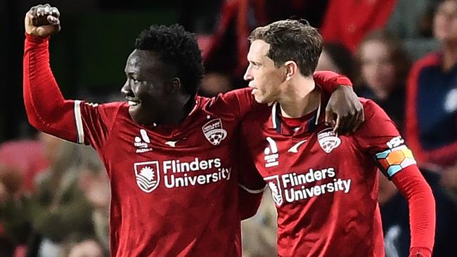 Nestory Irankunda celebrates with star teammate Craig Goodwin after his winner against the Roar. Picture: Mark Brake