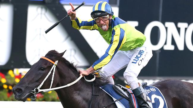 Damien Oliver celebrates as Lucia Valentina as they win the Longines Queen Elizabeth Stakes. Picture: AAP