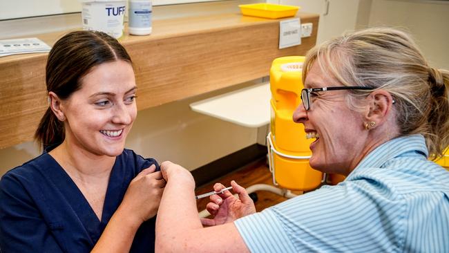 Nurse Emily Hooper gets her Pfizer vaccination from Maryanne Attard. Picture: Mike Burton.