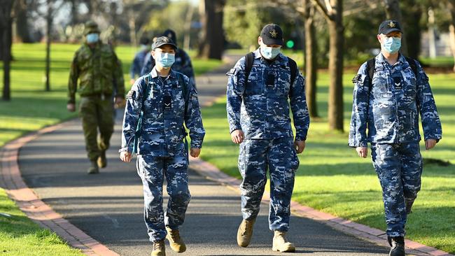 Members of the Australian Defence Force walk through Fitzroy Gardens. Picture: Quinn Rooney/Getty Images.