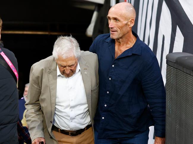 MELBOURNE, AUSTRALIA - APRIL 01: Tony Lockett helps Neil Roberts up the race during the 2023 AFL Round 03 match between the St Kilda Saints and the Essendon Bombers at the Melbourne Cricket Ground on April 1, 2023 in Melbourne, Australia. (Photo by Michael Willson/AFL Photos via Getty Images)