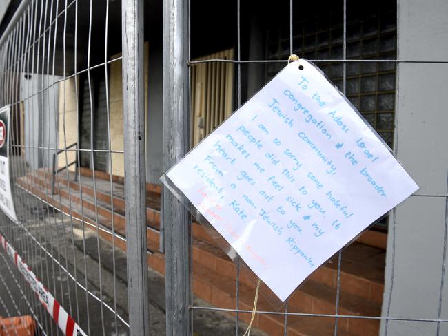 A note on the security fence of the Adass Israel synagogue the day after it was torched in fire. Picture: Andrew Henshaw