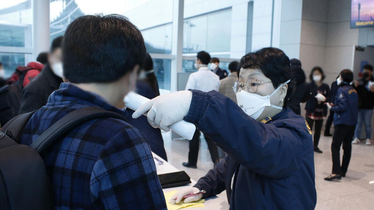 A South Korean quarantine officer checks passengers from an flight from Wuhan departed at Incheon international airport on January 22, 2020 in Incheon, South Korea. Picture: Korea Centers for Disease Control and Prevention via Getty Images