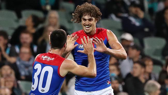 ADELAIDE, AUSTRALIA - APRIL 07: Luke Jackson of the Demons celebrates a goal with Alex Neal-Bullen as Travis Boak of the Power walks away during the 2022 AFL Round 04 match between the Port Adelaide Power and the Melbourne Demons at Adelaide Oval on April 07, 2022 In Adelaide, Australia. (Photo by Sarah Reed/AFL Photos via Getty Images)