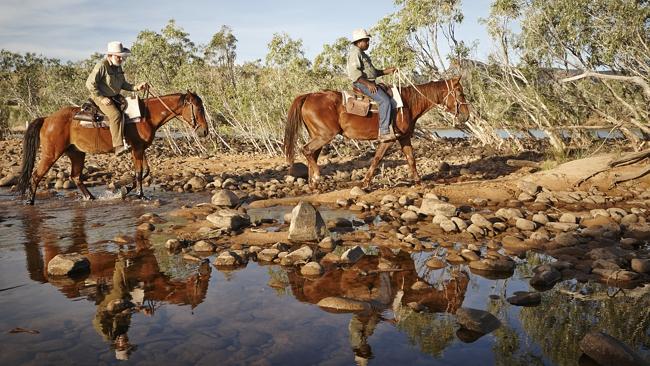  Stockmen Jason Newman and Cyril Yeeda cross the Pentecost River for the cameras to capture the reflections. Picture: Lisa Perko