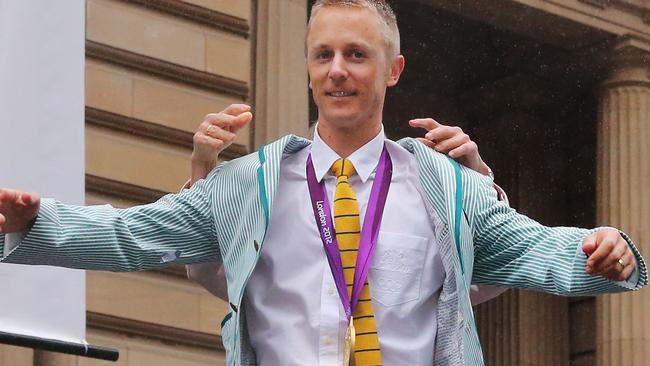 Jared Tallent puts on his Rio Olympics jacket after being awarded his gold medal last month for the 50km walk from the 2012 Olympic Games following the disqualification of Russian walker Sergey Kirdyapkin for doping