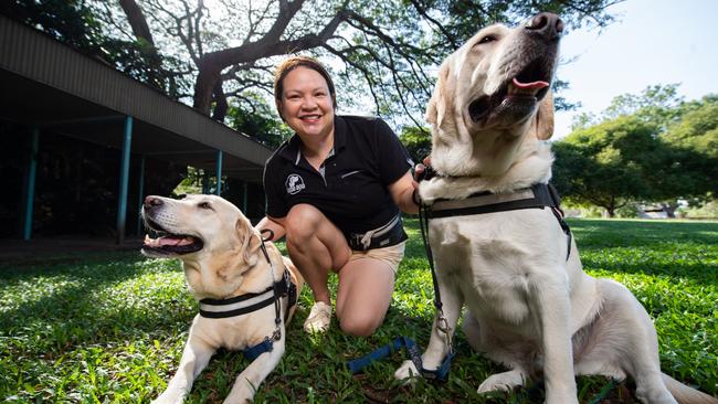 Good Dog Animal Assisted Intervention superstars Roxy and Quinton make a comforting presence with their trainer Hannah Taino-Spick. Picture: Charles Darwin University