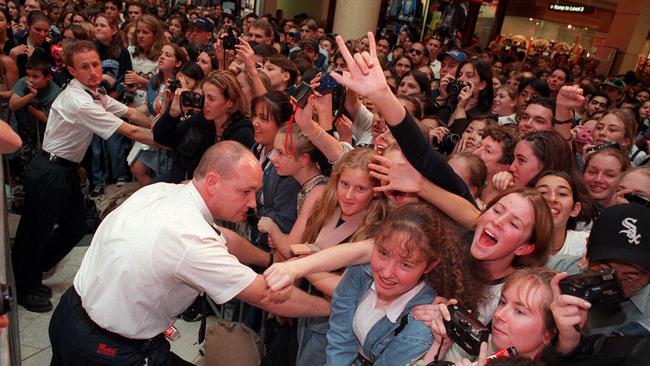 Security guards control hundreds of teenage fans to see Matt LeBlanc and his co-star Lacey Chabert.