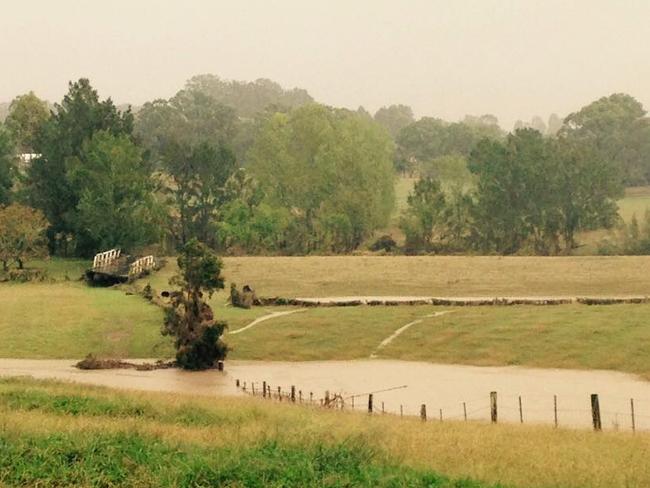 The bridge that connects Torryburn Road in East Gresford has been swept away entirely and landed in a paddock down stream. Picture: Louise Oliver