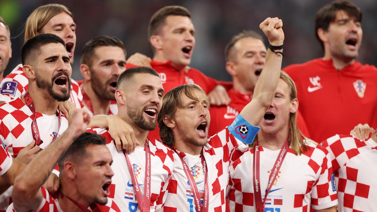 DOHA, QATAR - DECEMBER 17: Luka Modric of Croatia and teammates celebrate with their FIFA World Cup Qatar 2022 third placed medals after the team's victory during the FIFA World Cup Qatar 2022 3rd Place match between Croatia and Morocco at Khalifa International Stadium on December 17, 2022 in Doha, Qatar. (Photo by Richard Heathcote/Getty Images)