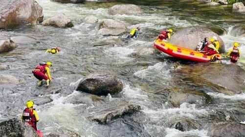 Members of the Cairns team of the Queensland Fire and Emergency Services Swiftwater Unit search for a woman who went missing after being swept away at Mossman Gorge in Far North Queensland. Picture: Supplied