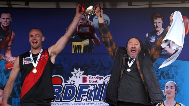 Riddell captain Joshua Grabham and coach Justin Belleville hold the premiership cup aloft. Picture: Hamish Blair