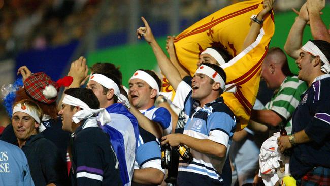 OCTOBER 12, 2003: Crowd on hill goes wild after try is scored during Scotland v Japan 2003 World Cup match at Dairy Farmers Stadium in Townsville, 12/10/03. Pic Bruce Long.Rugby Union / Fan