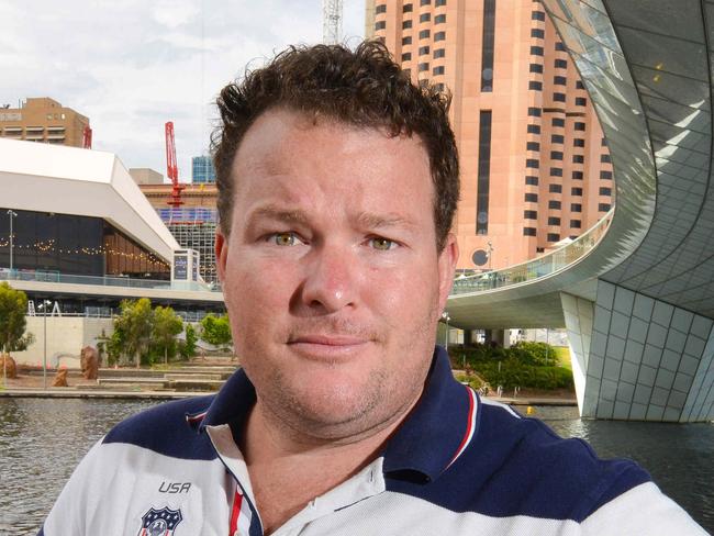 ANdrew 'Cosi' Costello at the River Torrens with the Riverbank development in the background, Tuesday, November 13, 2018. (AAP Image/ Brenton Edwards)