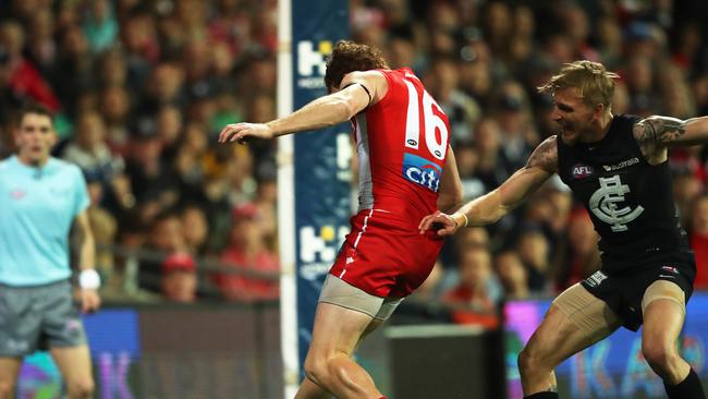 Sydney's Gary Rohan soccers through a goal and then ends up in the crowd falling over the fence. Picture: Phil Hillyard