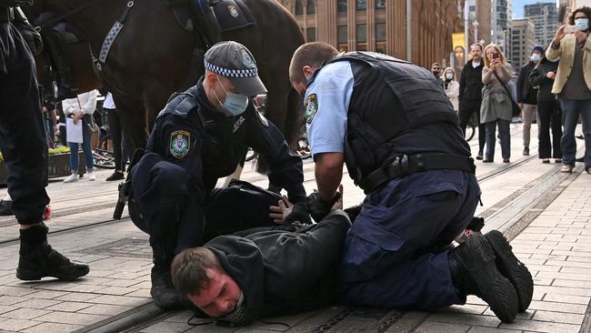 A man is arrested during the rally. Picture: NCA NewsWire/Bianca De Marchi