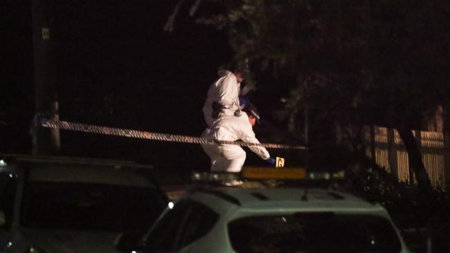 Forensic police at the crime scene late last night. Picture: Damian Hoffman