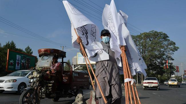 A man carries Taliban flags to sell at the Karte Mamorin area of Kabul city. Picture: AFP