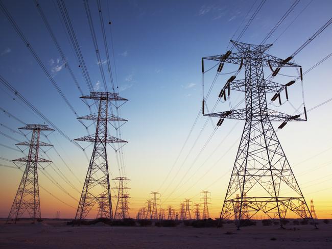 Power cables going in to the distance at dusk.