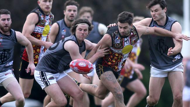 Goodwood’s Jacob Hughes tries to break through, with close attention from Port District’s Mitch Gaffney (R), and Cooper Gaffney (L). Picture: Dean Martin