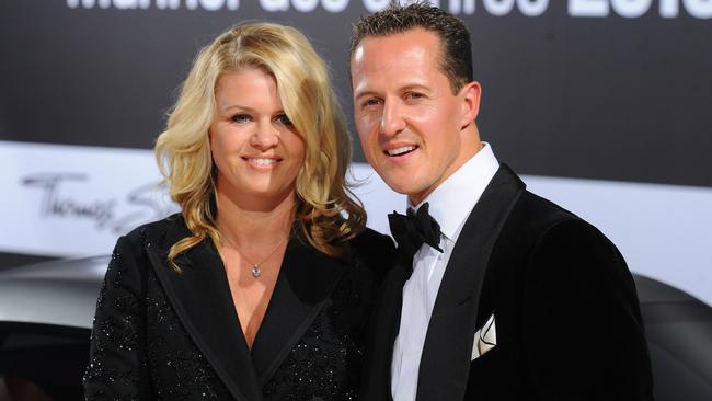 Schumacher with wife Corinna. Photo: AFP PHOTO / JENS KALAENE.