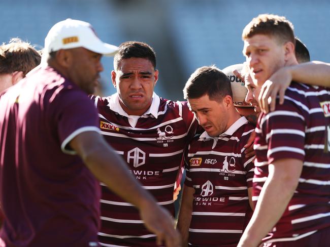 Maroons including Joe Ofahengaue and Ben Hunt (left and right centre) form a huddle with teammates during the Captain's Run at ANZ Stadium yesterday. Picture: Matt King/Getty Images