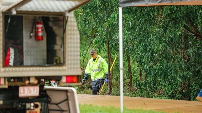 Police at the scene of the discovery of the body in a creek off Damabila Drive. Picture: Glenn Campbell