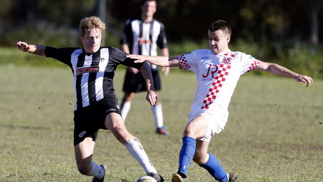 Murwillumbah's Troy Ruthven and Knight's Reuben Gailagher (right), in action at the Gold Coast Premier League match between the Gold Coast Knights and Murwillumbah, played at the Croatian Sports Centre, Carrara.