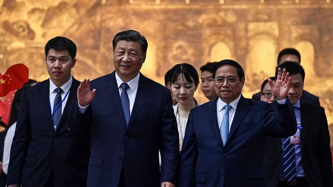 Vietnam’s Prime Minister Pham Minh Chinh (centre R) bids farewell to China's President Xi Jinping (centre L) after their meeting at the government office in Hanoi.