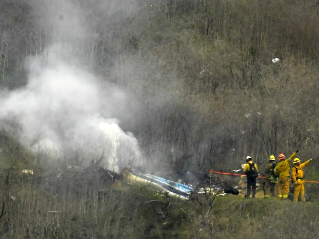 Firefighters at the scene of the crash. Picture: AP