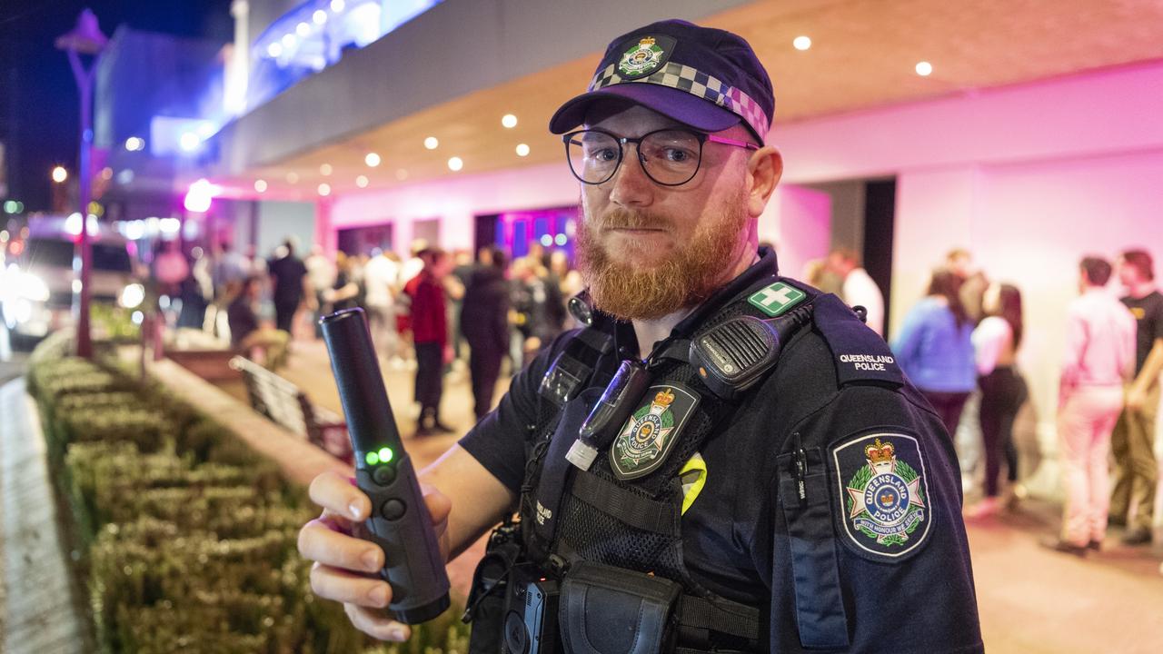 Toowoomba police officer Constable Luke Bianchi holds a hand held metal detector used in police scanning. Picture: Kevin Farmer