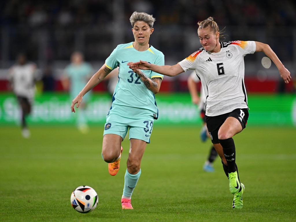 Matildas star Michelle Heyman is challenged by Germany’s Janina Minge. Picture: Getty Images