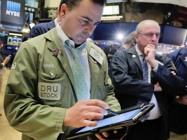 Trader Michael Iozzi, left, works on the floor of the New York Stock Exchange, Wednesday, Dec. 2, 2015. Stocks were mixed in early trading Wednesday ahead of a European Central Bank meeting where further stimulus is expected to be announced as well as a speech by the head of the Federal Reserve. (AP Photo/Richard Drew)