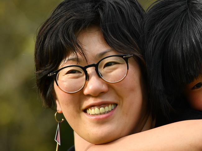 Artist Jung Yoon and her 10-year-old daughter Joanne who has autism pose for a photograph in Adelaide on Thursday the 19th of September 2019. Jung has come up with a project titled "Let's Be Friends", which includes a book, classroom learning resources and a documentary.  (AAP Image/Keryn Stevens)