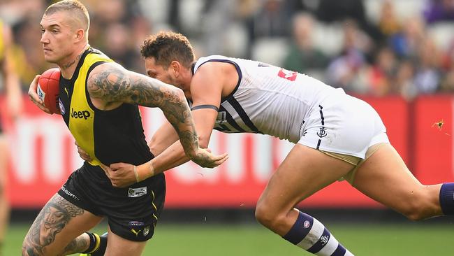 Michael Johnson tries to stop Dustin Martin in Round 8.