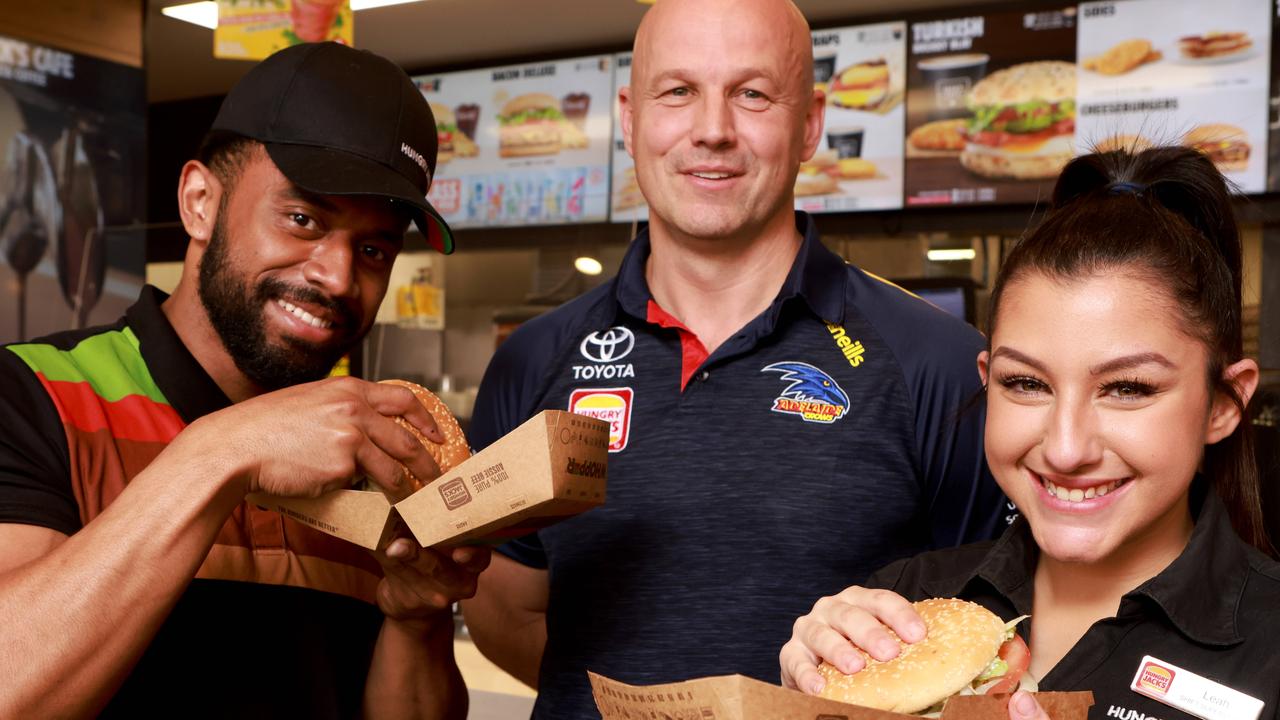 Nicks with Hungry Jack staff members Leah Farah and Amena Waqa after the food chain signed as a four-year sponsor with the Crows.