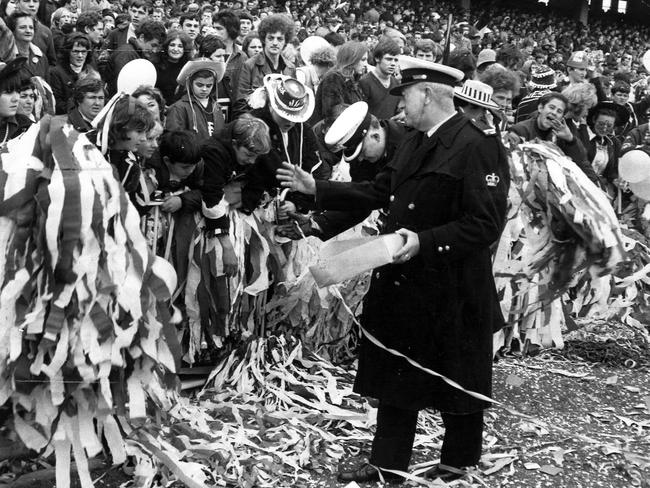 1969: Police warn Carlton supporters to take their floggers and streamers back inside the fence at the VFL semi-final between Collingwood and Carlton at the MCG.