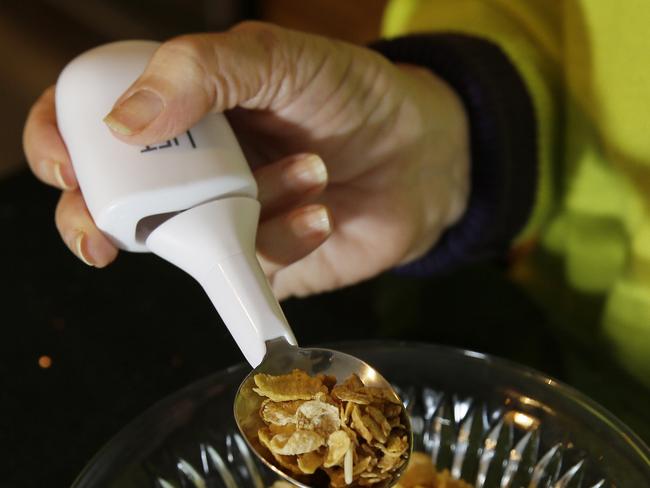 In this photo taken Thursday, Nov. 20, 2014, Shirin Vala, who is an essential tremor patient, uses a Liftward Spoon to eat without spilling at her home in Oakland, Calif. Just in time for the holidays, Google is throwing it’s money, brain power and technology at the humble spoon. Not surprisingly, the company that has brought the driverless car and Internet glasses is bringing a unique improvement to the utensils. Built with hundreds of algorithms, these specially designed spoons make it much easier for people with tremors and Parkinson’s Disease to eat without spilling. The spoons sense a shaking hand and make instant adjustments to stay balanced. (AP Photo/Eric Risberg)