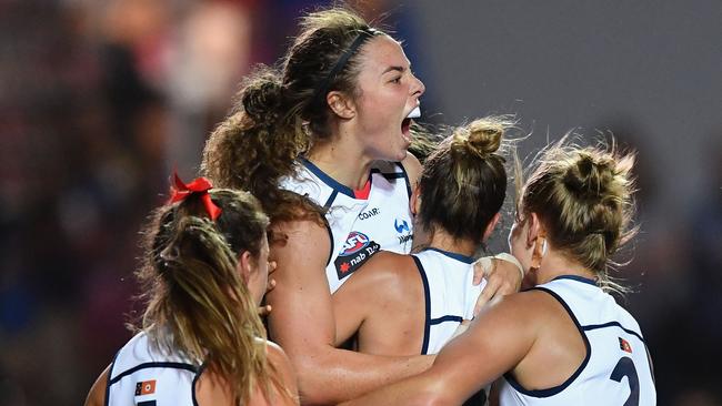 A jubilant Jenna McCormick is mobbed by Crows teammates after kicking a goal last weekend. Picture: Getty Images