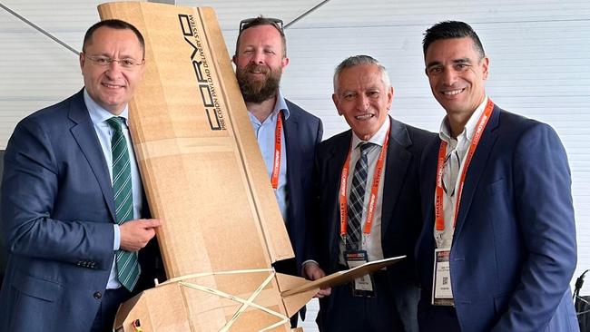 Ukrainian Ambassador Vasyl Myroshnychenko, left, with the cardboard drone and SYPAQ representatives, chief engineer Ross Osborne, founder and chairman George Vicino and managing director David Vicino.